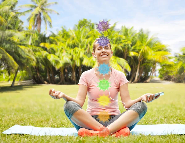 Woman meditating in summer park with seven chakras — Stock Photo, Image
