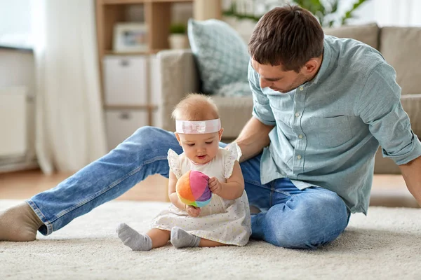 Vader en baby dochtertje met bal thuis — Stockfoto