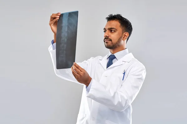 Indian doctor looking at spine x-ray — Stock Photo, Image