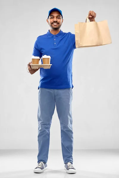 Happy indian delivery man with food and drinks — Stock Photo, Image