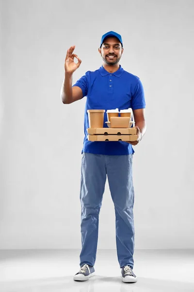 Delivery man with food and drinks showing ok — Stock Photo, Image