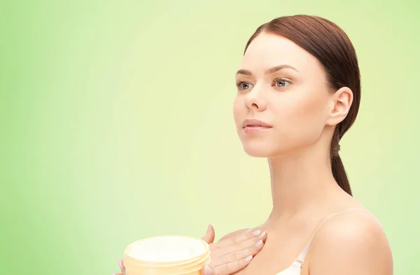 Beautiful woman with moisturizing cream — Stock Photo, Image