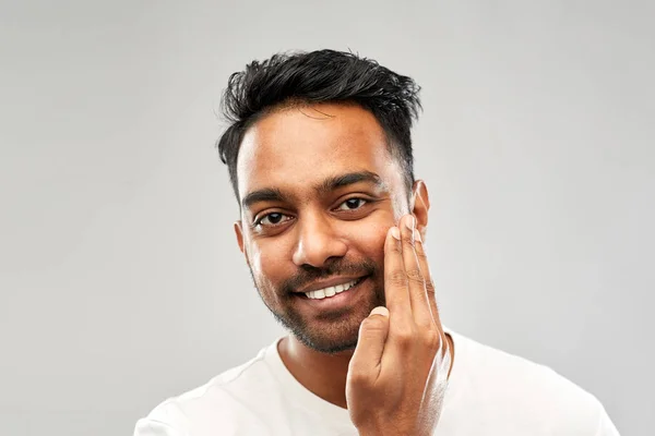 Lächelnder indischer Mann, der seinen Bart berührt — Stockfoto