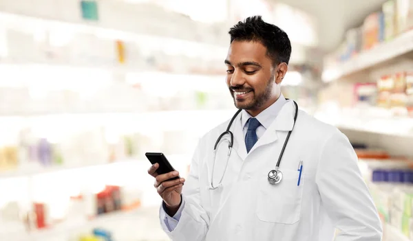 Sonriente médico indio masculino con teléfono inteligente — Foto de Stock