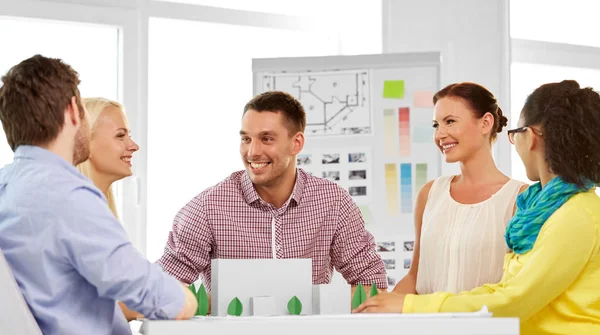 Creative team with blueprint working at office — Stock Photo, Image