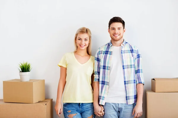 Счастливая пара с коробками переезжают в новый дом — стоковое фото