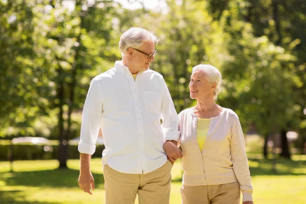 Happy senior couple walking at summer park — Stock Photo, Image