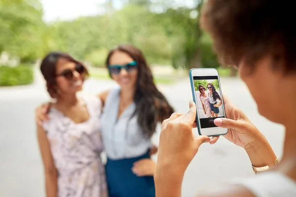 Mulher fotografar seus amigos no parque de verão — Fotografia de Stock