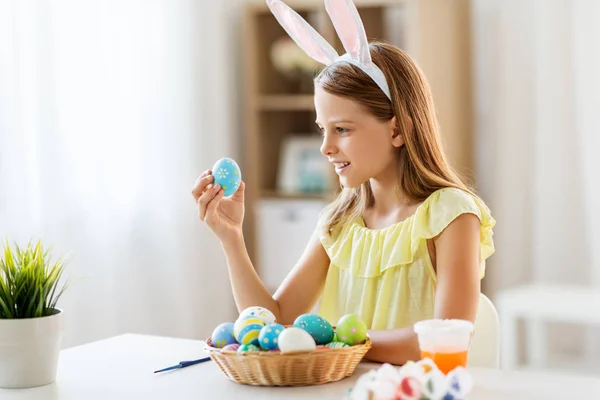 Glückliches Mädchen mit bunten Ostereiern zu Hause — Stockfoto