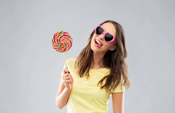 Menina adolescente em óculos de sol com pirulito — Fotografia de Stock