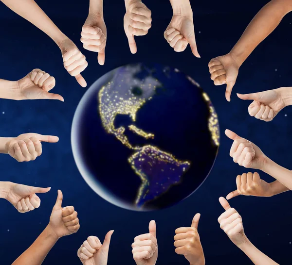Human hands showing thumbs up around earth planet — Stock Photo, Image