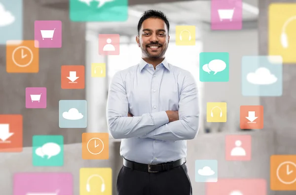 Empresário indiano com ícones de aplicativos no escritório — Fotografia de Stock