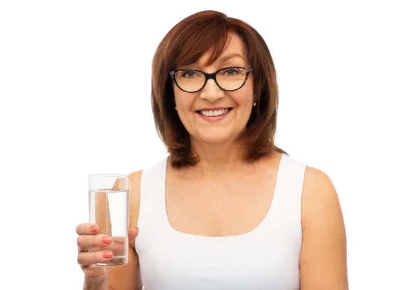 Senior woman in glasses with glass of water — Stock Photo, Image