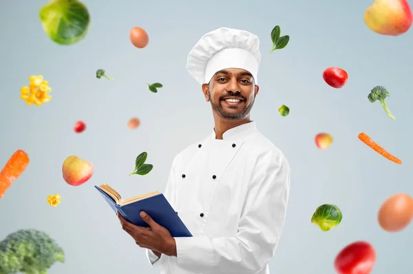 Chef indio feliz con libro de cocina sobre verduras —  Fotos de Stock