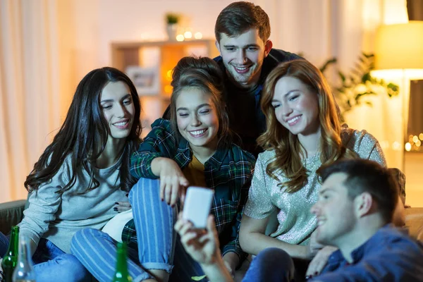 Amigos com smartphone assistindo tv em casa — Fotografia de Stock