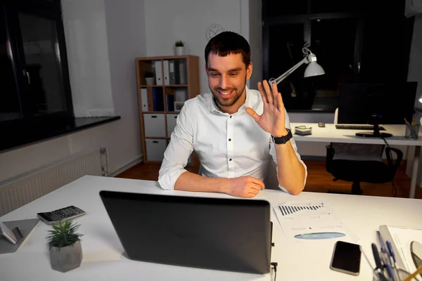 Businessman having video chat at night office — Stock Photo, Image