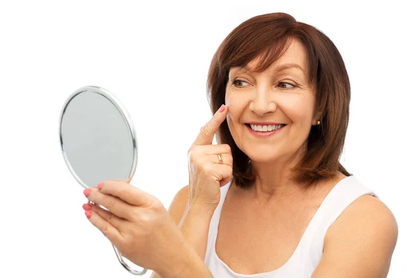 Retrato de mulher sênior sorridente com espelho — Fotografia de Stock