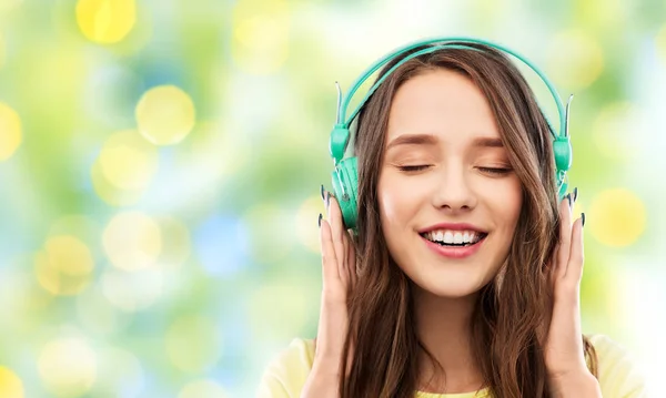 Šťastná mladá žena nebo dospívající dívka se sluchátky — Stock fotografie