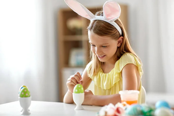 Happy girl coloring easter egg at home — Stock Photo, Image