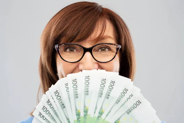 Senior woman with hundreds of euro money banknotes — Stock Photo, Image