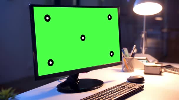 Computer met groen scherm bij nacht kantoor — Stockvideo