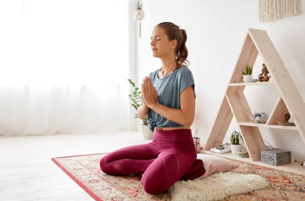 Nilüfer çiçeğiyle meditasyon yapan kadın yoga stüdyosunda poz veriyor. — Stok fotoğraf