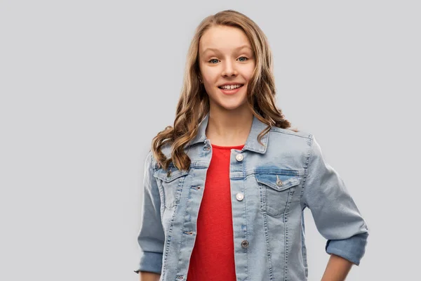 Smiling teenage girl in denim jacket — Stock Photo, Image