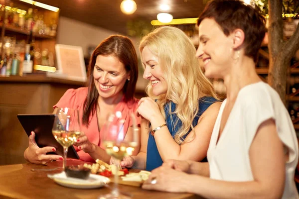 Kvinnor med TabletPC på vin bar eller restaurang — Stockfoto