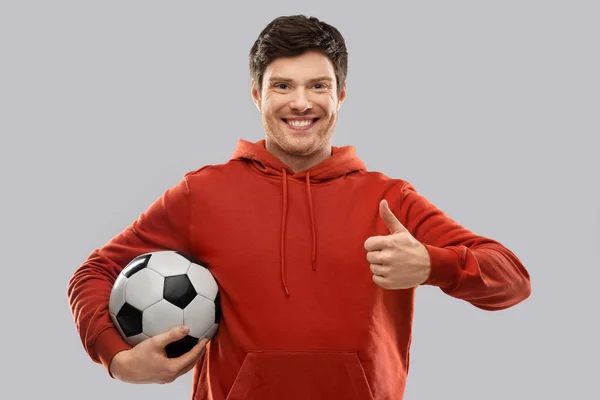 Male football fan with soccer ball shows thumbs up — Stock Photo, Image