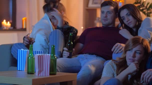 Przyjaciele z piwem i popcornem oglądający telewizję w domu — Wideo stockowe