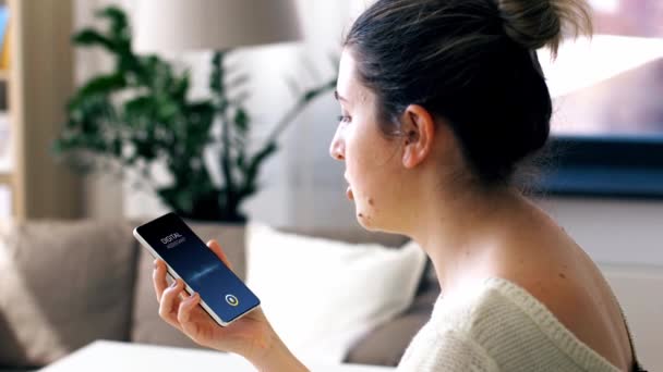 Young woman calling on smartphone at home — Stock Video