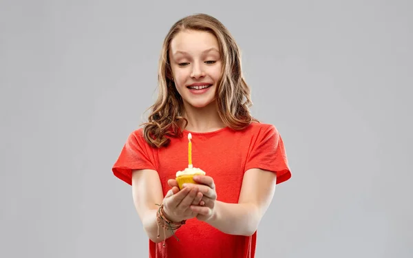 Teenage girl with one candle on birthday cupcake — Stock Photo, Image