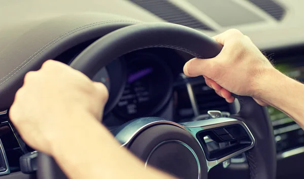 Close up of male hands driving car — Stock Photo, Image