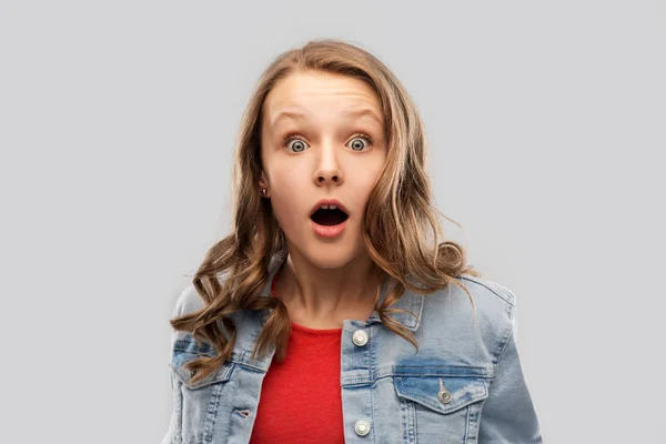 Surprised or shocked teenage girl in red t-shirt — Stock Photo, Image