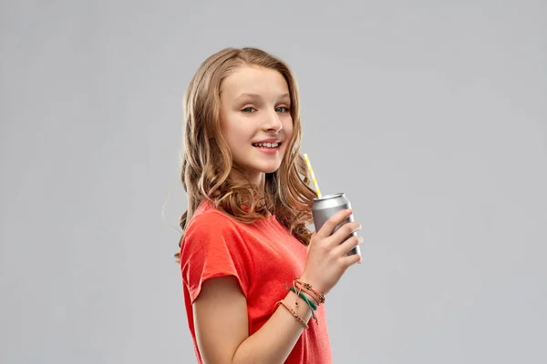 Girl drinking soda from can through paper straw — Stock Photo, Image