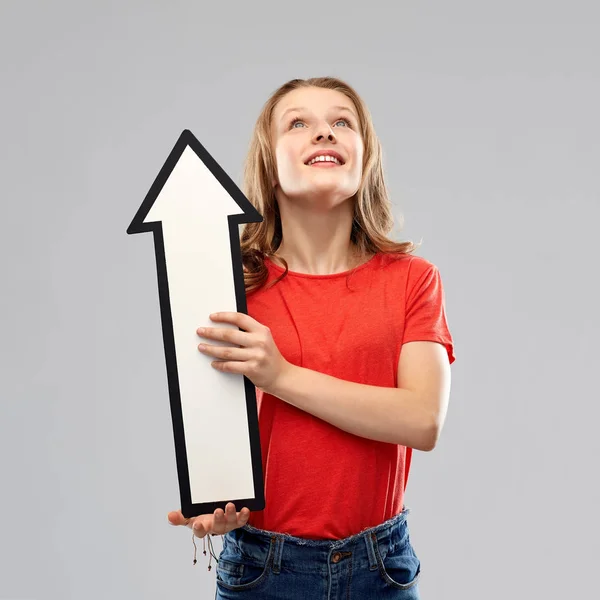 Smiling teenage girl with arrow showing direction — Stock Photo, Image