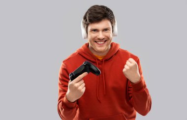 man with gamepad playing video game clipart