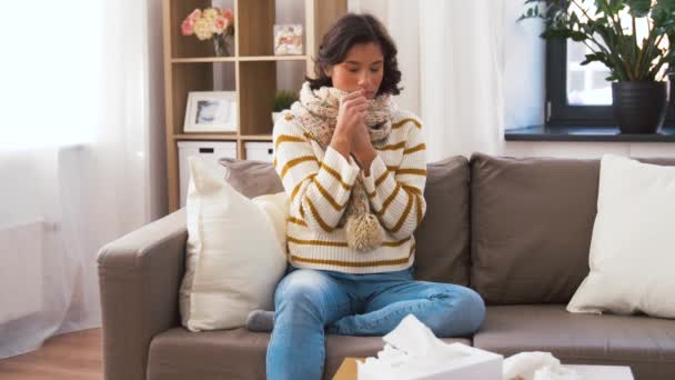 Unhappy sick woman in scarf coughing at home — Stock Video