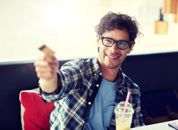 Hombre feliz pagando con tarjeta de crédito en la cafetería — Foto de Stock