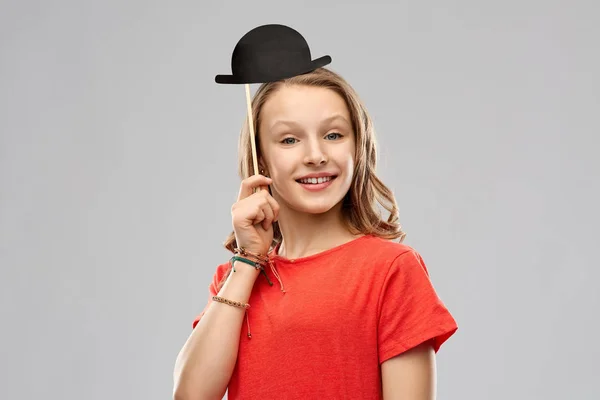 Smiling teenage girl with bowler hat party prop — Stock Photo, Image