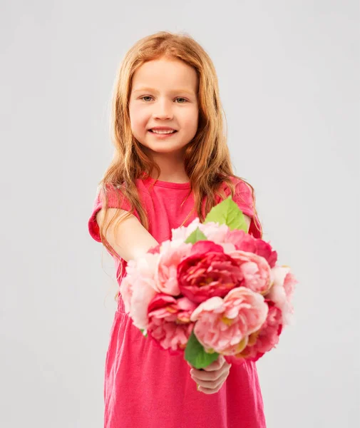 Happy red haired girl with flowers — Stock Photo, Image