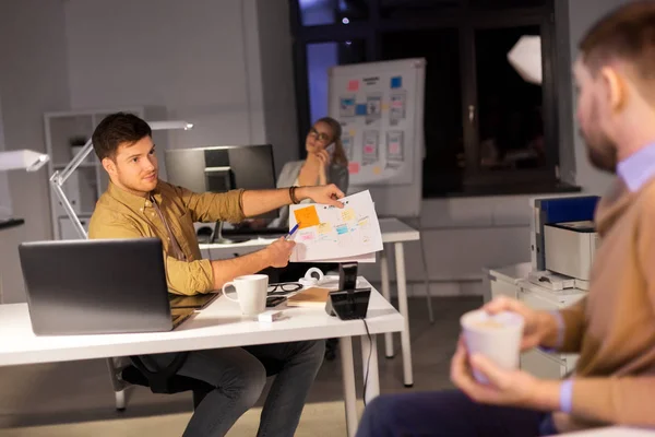 Business team with papers working late at office — Stock Photo, Image