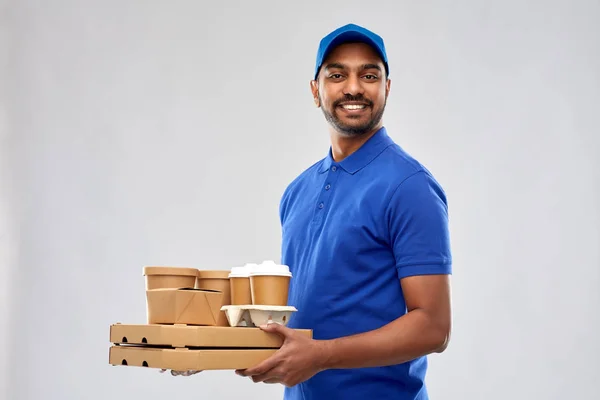 Happy indian delivery man with food and drinks — Stock Photo, Image