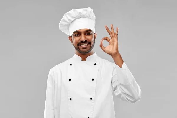 Happy male indian chef in toque showing ok gesture — Stock Photo, Image