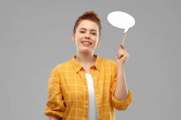 Red haired teenage girl holding speech bubble — Stock Photo, Image