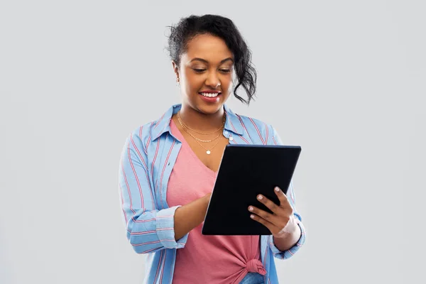 Щаслива афроамериканська жінка використовує планшетний ПК — стокове фото