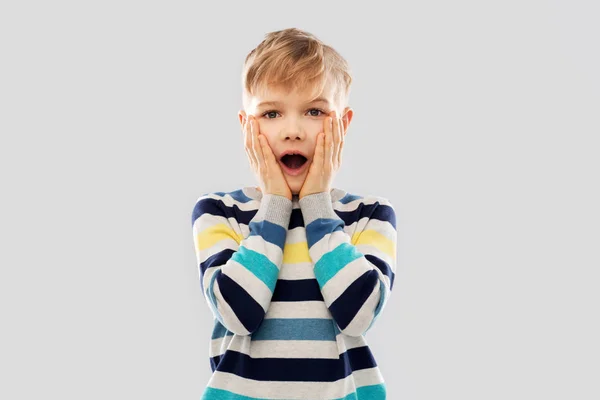 Shocked little boy in striped pullover — Stock Photo, Image