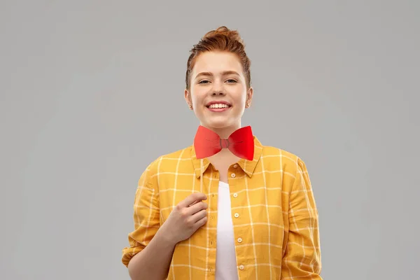 Smiling red haired teenage girl with big bowtie — Stock Photo, Image