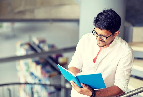 Hindu student boy or man reading book at library — Stock Photo, Image