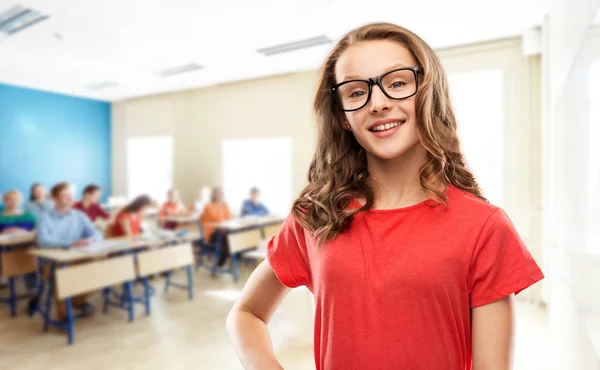 Chica estudiante sonriente en gafas en la escuela —  Fotos de Stock